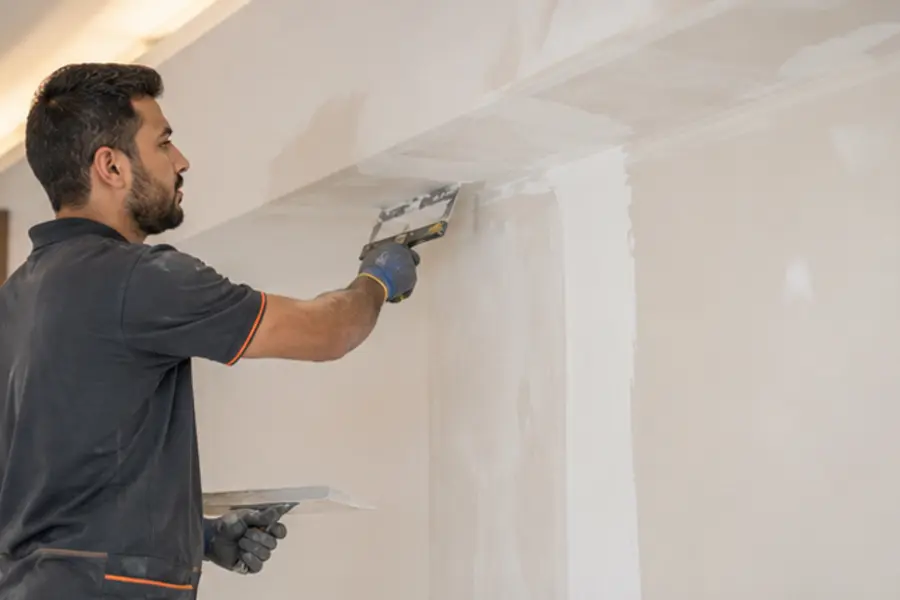 Craftsperson completing detailed interior finishing